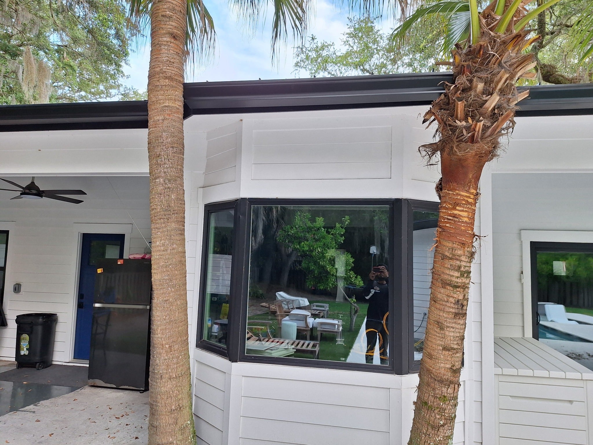 Black seamless gutters tracing a modern home's roofline